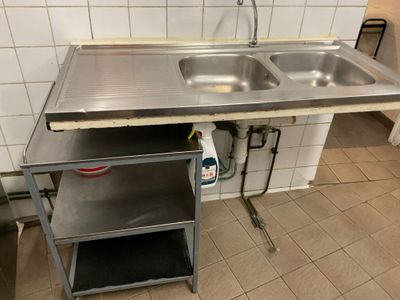a sink and a shelf in a small kitchen
