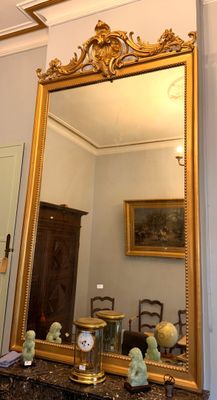 a mirror on a table in a room with a mirror on the wall