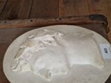 a white plate with a face on it on a table