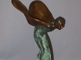 statue of a woman holding a baseball bat on a black base