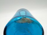 a blue glass vase with a fish inside of it