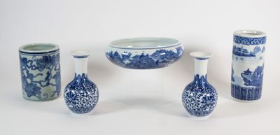 several blue and white vases and a bowl on a white surface