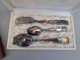 four spoons and a fork in a box