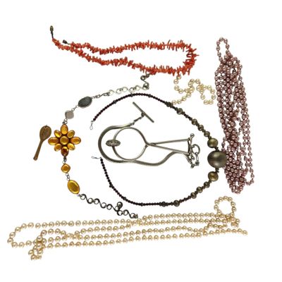 a lot of different necklaces and bracelets on a white background