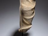 a sculpture of a head on a wooden stand