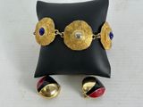 a close up of a pillow with a pair of earrings on it