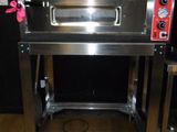 an image of a stainless steel oven on a wooden floor