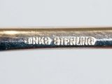a close up of a silver spoon with a handle