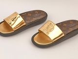 pair of louis vuitti slides with gold metal hardware