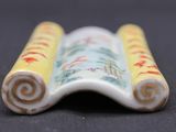 a close up of a small ceramic object on a table