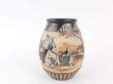 a vase with a picture of a man riding a horse on it