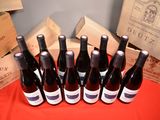 several bottles of wine are lined up on a table