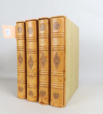 three books are stacked on top of each other on a white surface