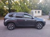 a picture of a grey suv parked in a parking lot