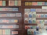 many different stamps on display in a glass case