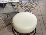 a white ottoman sitting on top of a tiled floor
