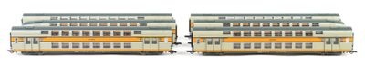two trains that are sitting side by side on the tracks