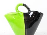 a black and green vase with a handle on it