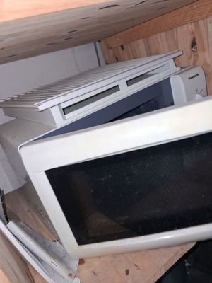 a microwave sitting on top of a wooden table