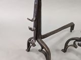 pair of antique cast iron candlesticks on stands on a white background