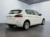 the rear end of a white car parked in a garage