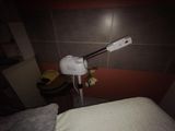 a lamp that is on top of a bed in a room