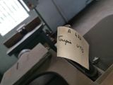 a piece of paper with writing on it sitting on a toilet