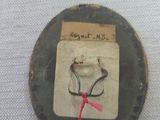 a small piece of paper with a red string on it