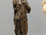 a statue of a woman holding a vase next to a statue of a man
