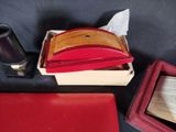 a red box with a wallet and a glass of wine next to it