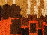 a close up of a rug with different colors and patterns