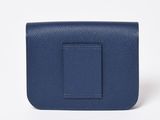 a picture of a small blue purse with a square buckle