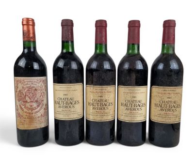 six bottles of wine are lined up in a row on a white surface