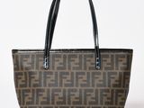 a brown and black tote bag on a white background