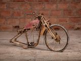 an old motorcycle that is sitting in the dirt