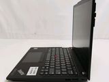 a black laptop computer sitting on a white surface