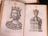 a book with a drawing of a woman wearing a crown on top of it