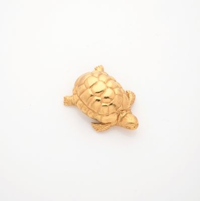 gold plated turtle broochle on a white background