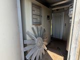 a large metal fan sitting in the corner of a room