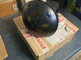a black helmet sitting on top of boxes on a table
