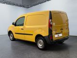the yellow van is parked in a large room with a gray floor