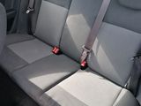 two seats in the back of a car with a seat belt