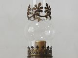 an old fashioned oil lamp is sitting on a table