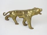 brass figurine of a lion on a white background