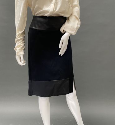 an image of a mannequin wearing a black skirt and white shirt