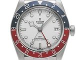 a close up of a wrist watch with a red, white and blue bezel