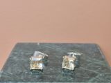 pair of silver and crystal cuff earrings on a marble block