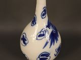 a blue and white vase sitting on a table