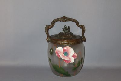 a glass jar with a flower painted on it