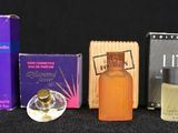 many different types of perfumes on a black surface